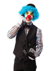 portrait of a funny clown talking on telephone