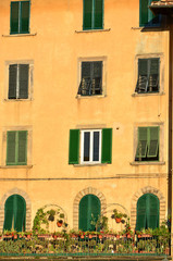 Fototapeta na wymiar Italian Architecture, green shuttters and ocher walls