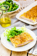 Puff pastry pasty with bechamel sauce, ham and cheese