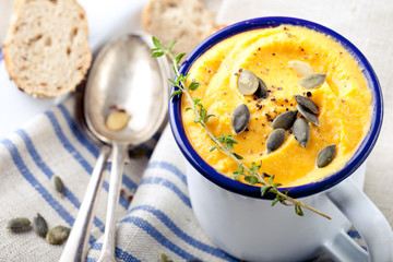 Roasted pumpkin and carrot soup with cream . 
