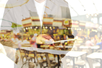 Double Exposure of Business Man using Mobile Tablet PC with Rest
