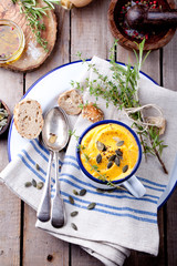 Roasted pumpkin and carrot soup with cream . 