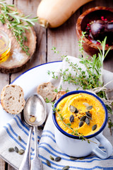 Roasted pumpkin and carrot soup with cream . 