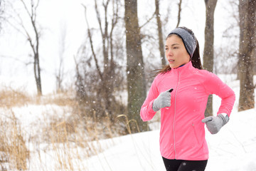 Winter jogging - woman runner running in cold air
