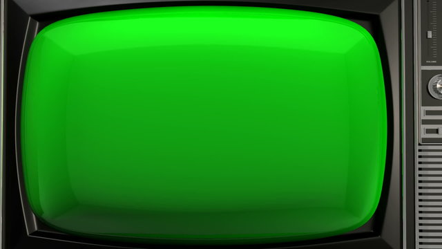 A zoom out from the green screen of a vintage wood plastic and chrome television