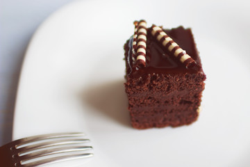 piece of cake on a white plate with a fork
