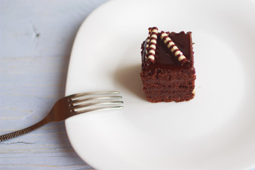 piece of cake on a white plate with a fork
