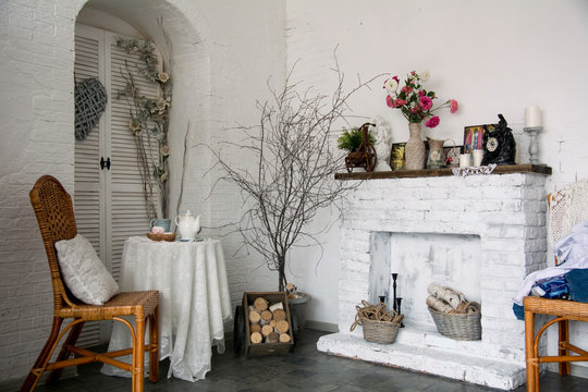 The design interior rustic room with a fireplace, flowers, chair
