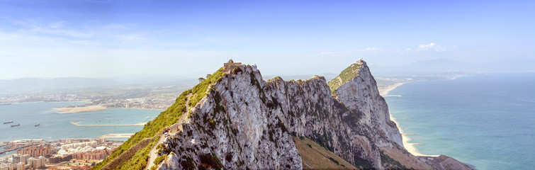 A breathtaking panorama of Gibraltar, with a cable car ascending the rock, offering stunning views...