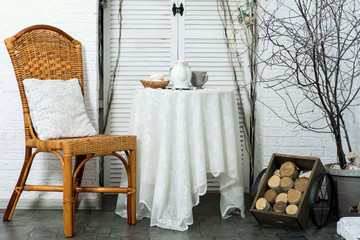 A table covered with thick cloth with a cup of tea and tea and m