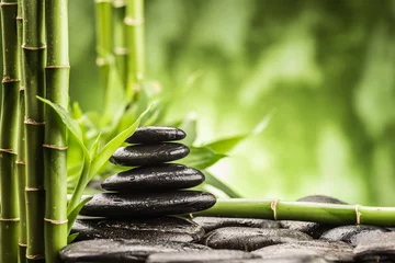 Fotobehang spa-concept met zen basaltstenen en bamboe © Pavel Timofeev
