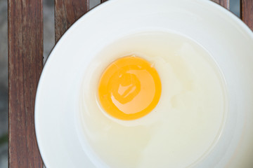 raw egg yolk on the dish on table