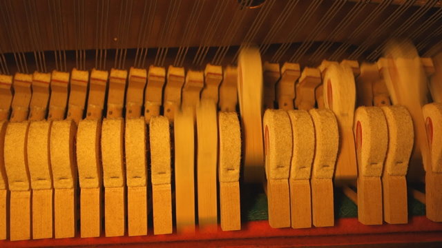 inside piano, hammer hitting strings