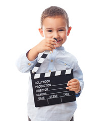 portrait of a little boy holding a clapper board