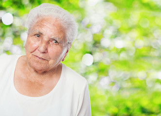 adorable old woman face closeup over abstract background