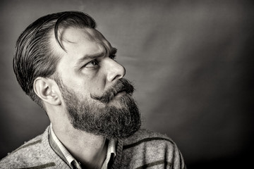 Closeup of a handsome young man with retro look over gray background
