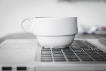 coffee cup put on laptop