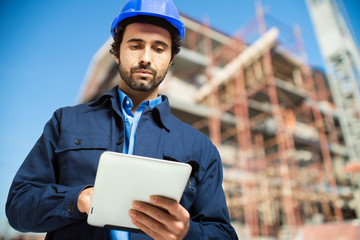 Construction specialist using a tablet computer