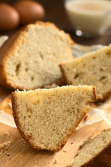 Eggnog cake slice photographed with natural light (Selective Focus, Focus on the standing cake slice)