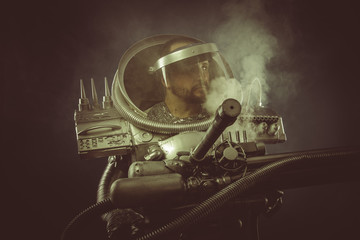 Fototapeta na wymiar Environmental, spaceman with plasma gun and helmet glass