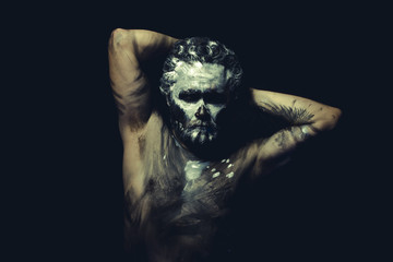 Dance, wild man with white painted face and full body black pain