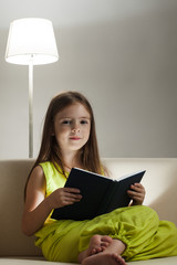 beauty girl read book on sofa
