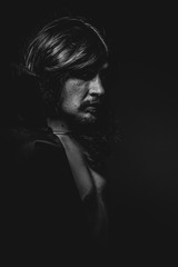 Lips, vampire man with great contrasts of light, large black clo