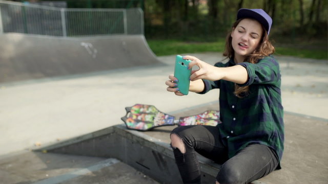 Girl doing selfies in the skate park and enjoying it
