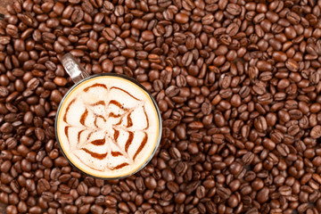 A meticulously crafted café latte adorned with intricate decorations and a chocolate heart nestled amidst aromatic roasted beans fostering an inspiring environment conducive to scholarly pursuits