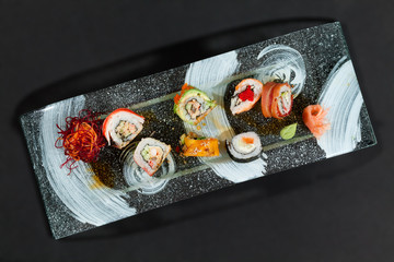 Delicious and fresh sushi plate beautifully presented on a sleek black background in a professional studio setting.