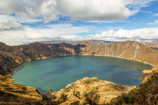 Indulge in the breathtaking panorama of the Quilotoa Crater lagoon nestled amidst the Ecuadorian Andes showcasing the serene beauty of this dormant volcanic wonder