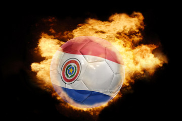 Fototapeta premium football ball with the flag of paraguay on fire
