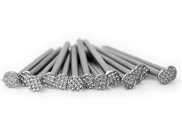 A pile of isolated carpentry tools with a nail and hammer at the head.