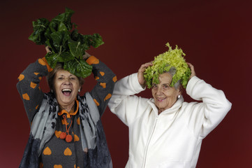 Two senior women playing with chard and endive