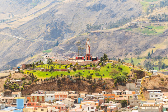 A picturesque building in Alausi, Ecuador with the majestic Chimborazo volcano towering in the background. A must-see destination for travelers.
