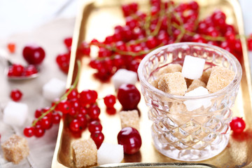 Fresh red currants with sugar on metal tray close up