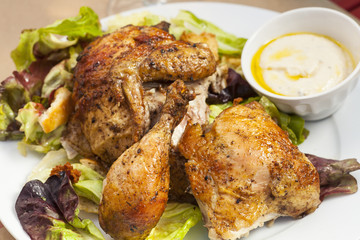 crispy free-range rotisserie chicken on organic butterleaf salad