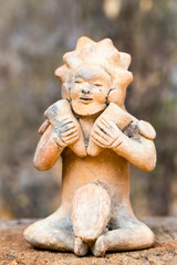 Uncover the intriguing artifact of a ceramic male figure symbolizing a woman holding two hammers a fascinating relic from Ecuador's ancient Tolita culture dating back to 500 BCE to 500 CE