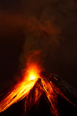 A powerful eruption from the volcano sends dark clouds of magma into the sky, glowing with intense...