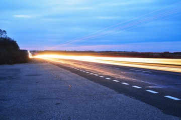 Streaks of light from car headlights on the road