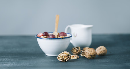 breakfast with cornflakes and milk on dark wooden table