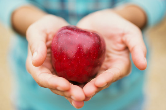 Woman Holding a red apple
