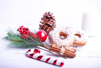 Christmas donuts on white wooden table