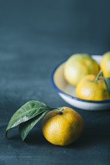 filtered photo of fresh mandarin fruits on dark blue wooden table