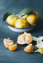 filtered photo of fresh mandarin fruits on dark blue wooden table