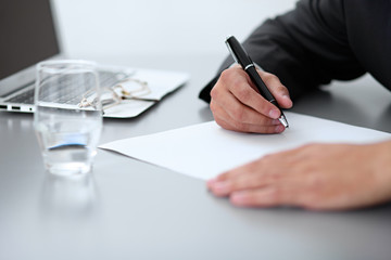 Close-up of male hands with pen over document,  business concept