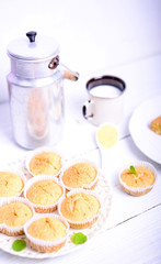 Cornbread muffins and milk on white table