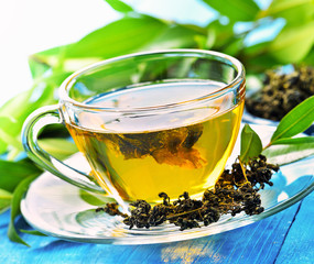 Cups of green tea on table on wooden background