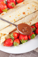 Pancakes with chocolate and strawberries