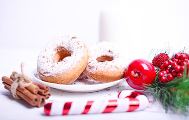 Donuts for Christmas breakfast on white wooden table closeup